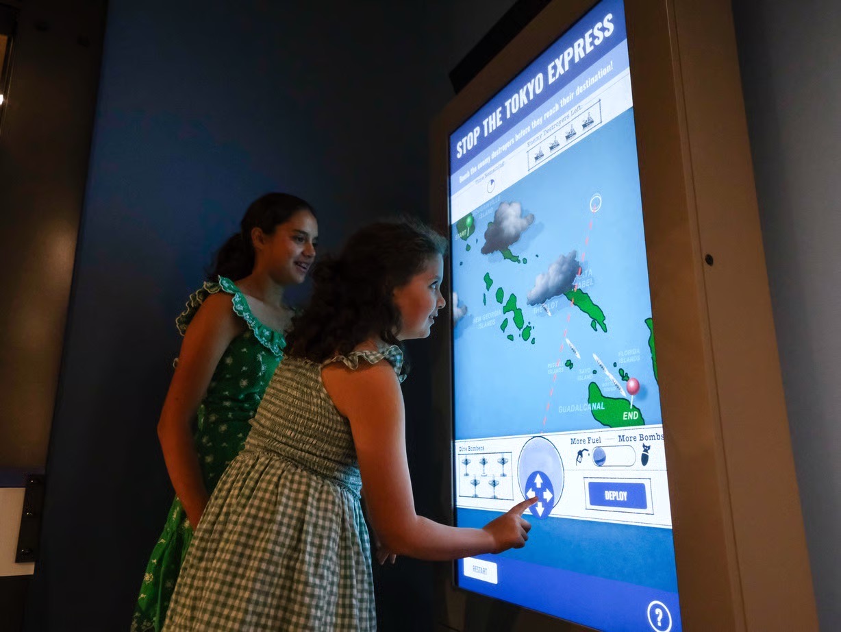 The installed Stop the Tokyo Express touchscreen on the floor of the Bush Gallery at the National Museum of the Pacific War